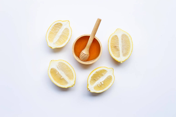 Honey with lemon on white background. Copy space - Photo, Image