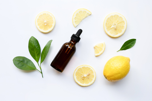 Fresh lemon with lemon essential oil on a white background. - Фото, зображення