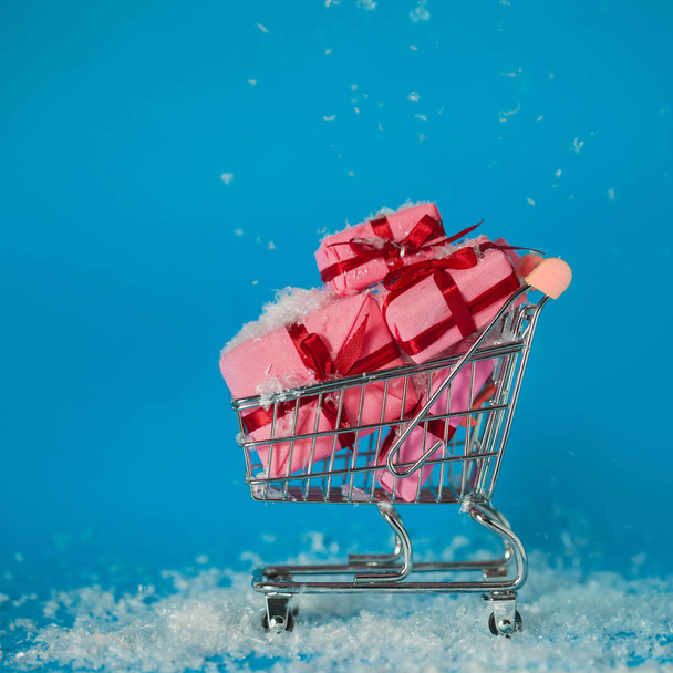 Christmas sales. Buying gifts for the new year, the concept. The shopping cart is full of gift boxes - Fotó, kép