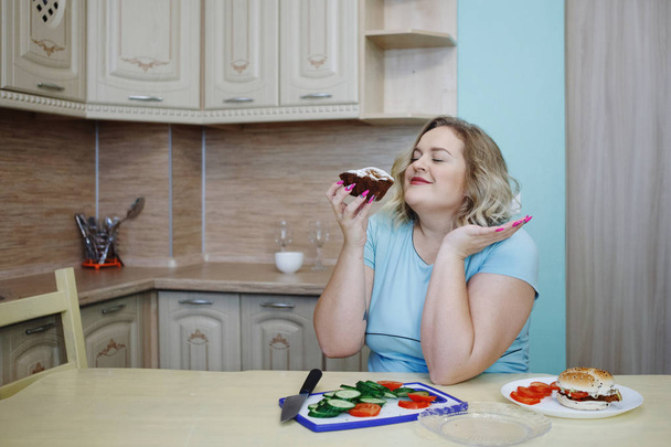 Fat woman feeling guilty while eating junk food - Photo, Image