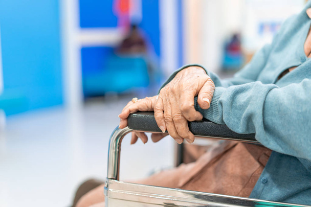Closeup Elder patient woman hand on wheelchair waiting doctor in hospital - Photo, Image