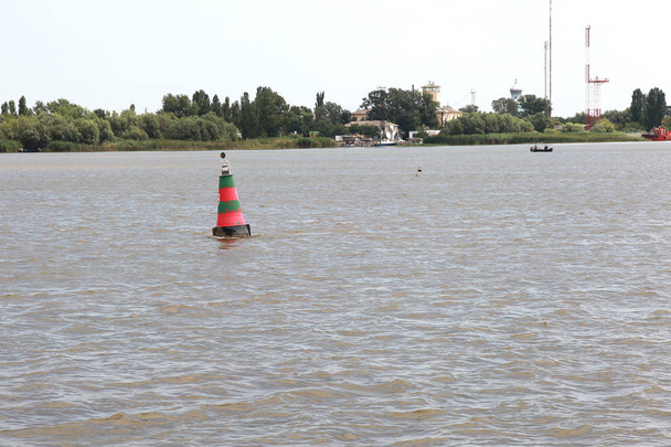 Navigációs bója, a folyó hajózható Duna torkolatánál. Navigációs bója a hajózható folyó mentén mutatja az utat a folyosón, a hajók - Fotó, kép