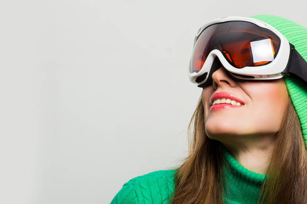Active young ski woman portrait wearing winter clothing isolated over white - 写真・画像
