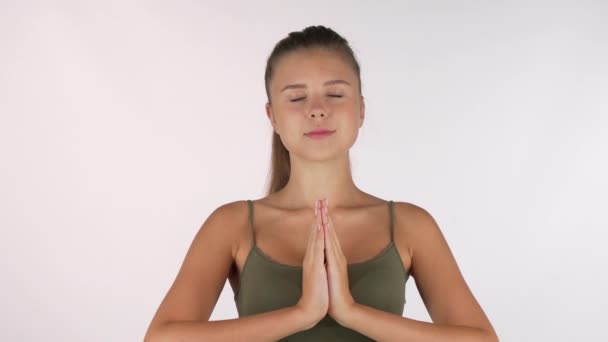 Beautiful young woman meditating with eyes closed isolated - Πλάνα, βίντεο