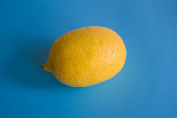 Citron jaune mûr isolé sur le fond bleu
 - Photo, image