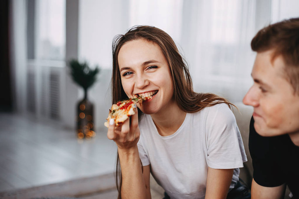 young attractive woman enjoy pizza, close up. - Фото, изображение