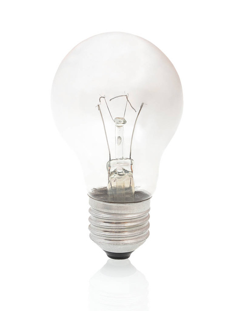Burned-out light bulb isolated on white background with shadow reflection. Burned light bulb on white backdrop. Burned incandescent light bulb. - Photo, Image