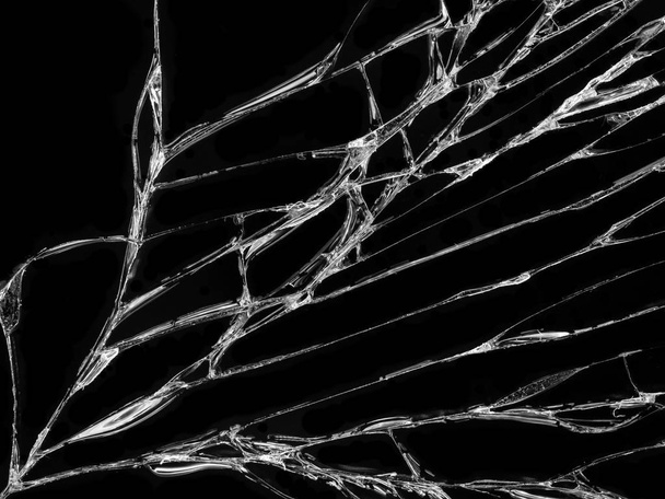 Cracked glass texture on black background. Isolated realistic cracked glass effect. - Photo, Image
