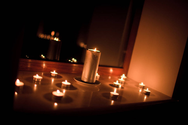 Candles by the mirror. Romantic date - Fotografie, Obrázek
