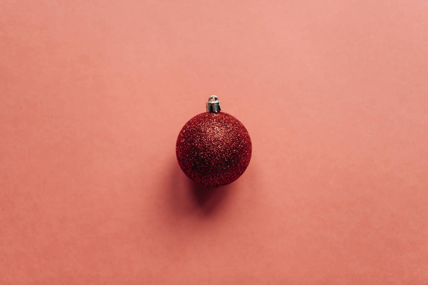 Red Christmas ball on a red background. - Photo, Image