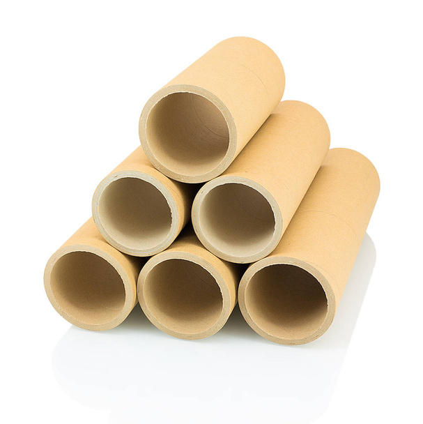 A bunch of brown industrial paper core isolated on white background with shadow reflection. A lot of paper cores or paper tubes on white backdrop. Brown paper rolls. - 写真・画像