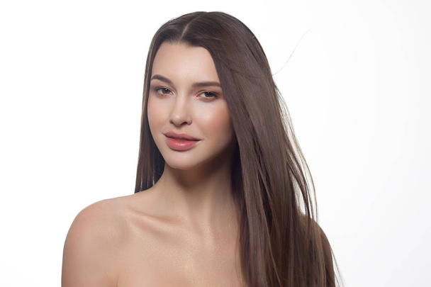 Close-up of beauty girl with long straight developing hair and radiant daytime makeup on her face. Skin care natural cosmetics in the spa salon or cosmetology. - Fotografie, Obrázek