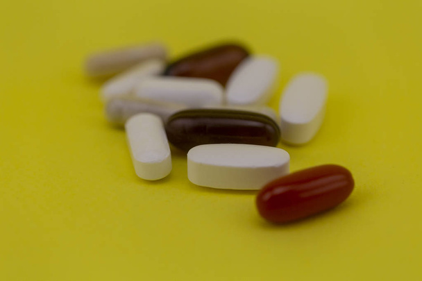 pills close-up on yellow background - Foto, imagen