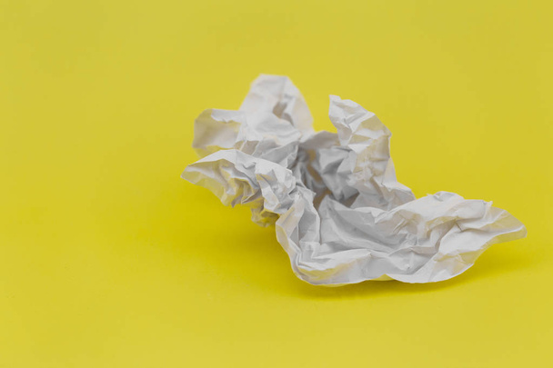 crumpled sheet of white paper on yellow background - Photo, Image