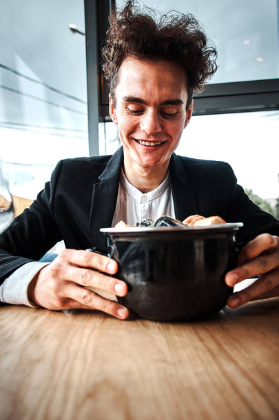handsome young businessman eating seafood in a luxury restaurant - Foto, Bild