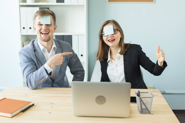 Business, break and people concept - Cheerful man and woman playing games in office while working - Foto, Bild