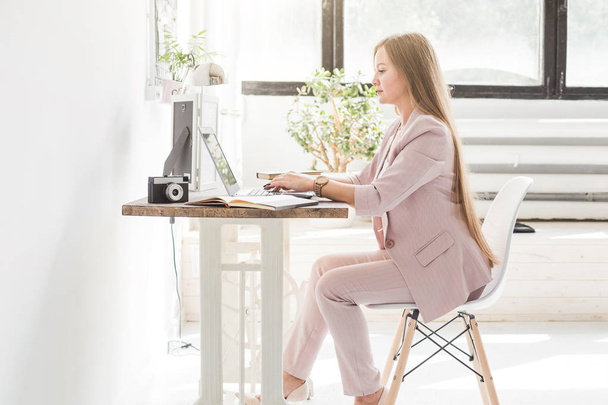 Young business woman working at home. Creative Scandinavian style workspace - Fotó, kép
