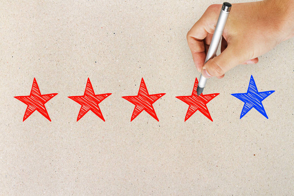 Hands with five star rating on light background. Ranking and leadership concept - Фото, изображение