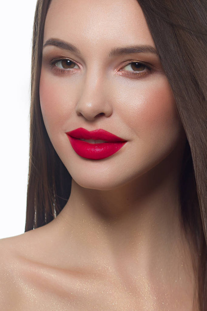 Close-up portrait of sexy european young woman model with classic glamour make-up and pink lipstick. Dark long hairstyle, christmas makeup, dark eyeshadows, bloody lilac lips with gloss - Фото, изображение