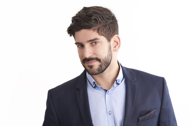 Studio business portrait of young professional man wearing suit while standing at isolated white background and looking at camera. - Φωτογραφία, εικόνα