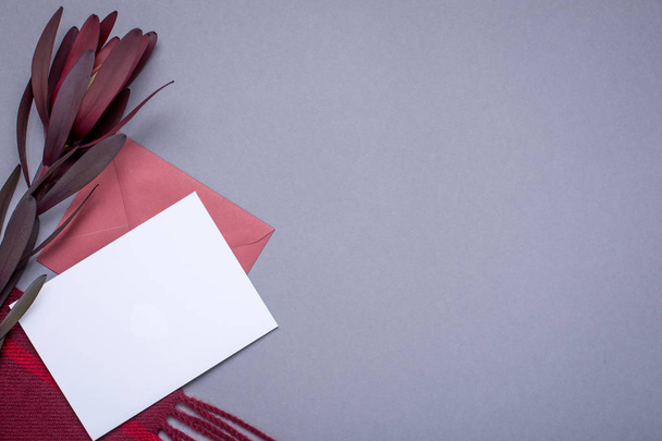 Grey wallpaper with gift card and burgundy wrap top view - Photo, image