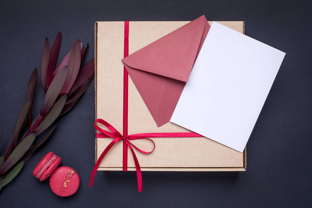 Present card and gift in box with satin ribbon on dark background top view - Foto, Imagem