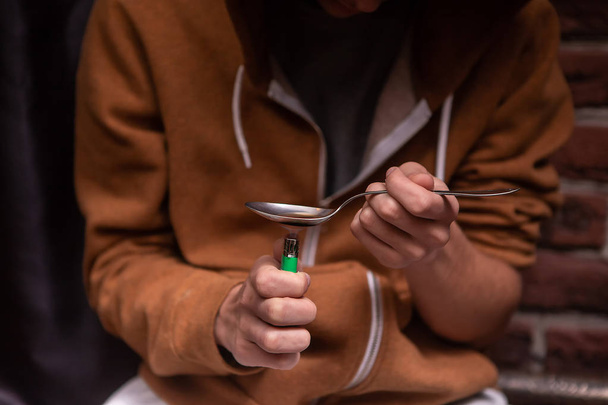 An addict makes a drug. Stop the drugs. Dangerous habit. Close-up - Foto, Imagen
