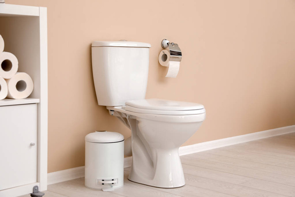 Holder with toilet paper roll on wall in bathroom - Fotó, kép