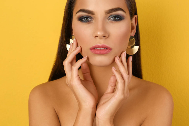 Portret van mooie vrouw met stijlvolle make-up op kleur achtergrond - Foto, afbeelding
