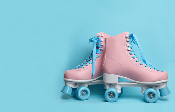 Pair of stylish quad roller skates on color background. Space for text - Foto, Imagem