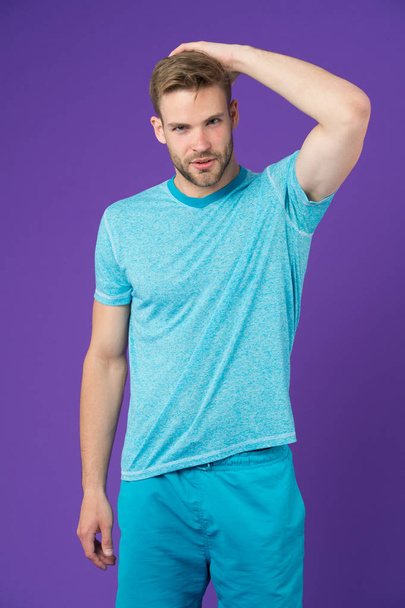 Masculinity concept. Man with muscular arms confident and strong. Does having muscular body make you more confident. Strong and muscular. Man strict handsome unshaven guy on violet background - Photo, image