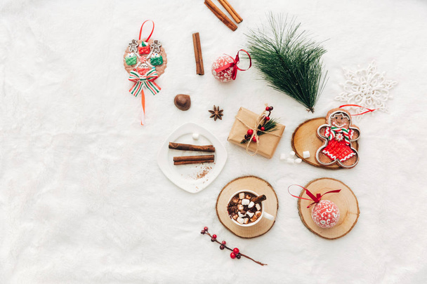 Christmas decorative composition. Flat lay with hot chocolate and holiday decorations on white background. Cozy composition for bloggers. - Photo, image