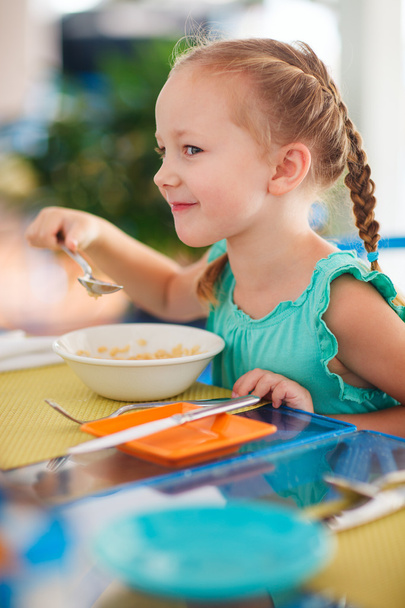 Little girl having breakfast - Фото, изображение