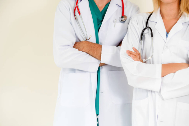 Porträt des selbstbewussten gp-Arztes und chirurgischen Arztes mit verschränkten Armen auf weißem Hintergrund. - Foto, Bild