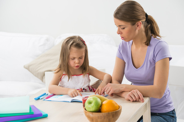 Portrait of adorable young girl and mother studying drawing - Fotoğraf, Görsel