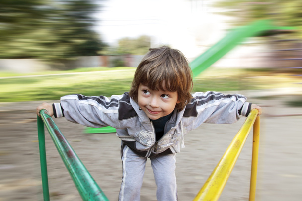 happy boy on carousel outdoors - Фото, зображення
