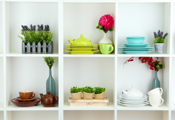 Beautiful white shelves with tableware and deco - Foto, imagen