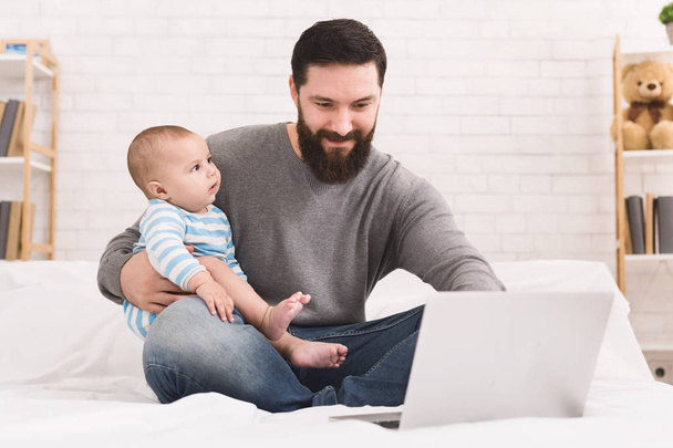 Businessman working from home and watching child - Photo, Image