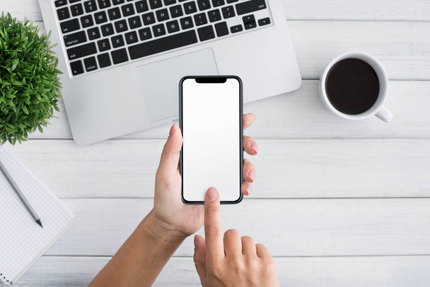 Hand using smartphone on white wooden background - Foto, Bild