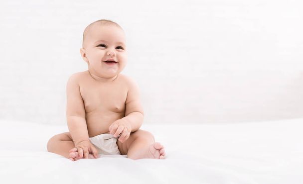 Cute baby sitting on white background, copy space - Фото, зображення