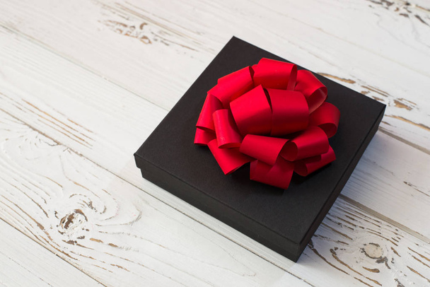 Holiday black Gift box with red bow - Valokuva, kuva