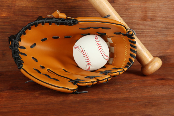 Baseball glove, bat and ball on wooden background - Foto, Bild