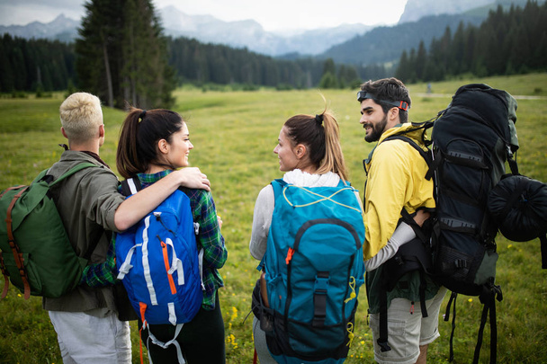 Group of friends on a mountain. Young people on mountain hike - Fotoğraf, Görsel