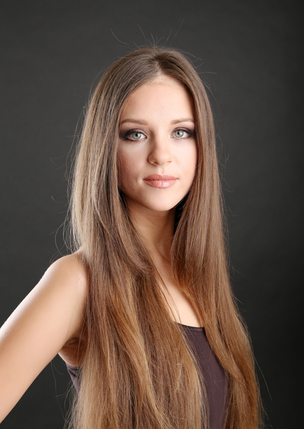 Portrait of beautiful woman with long hair on black background - Foto, Imagem
