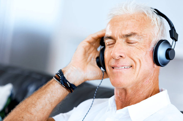 Handsome gray haired senior man with headphones - Photo, Image