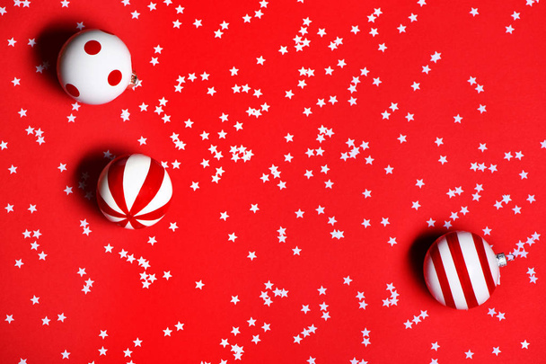 Christmas toys with confetti on red background. - Foto, immagini