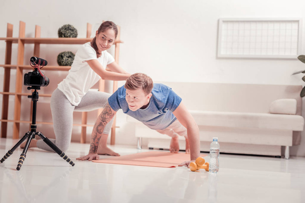 Couple exercising together at home - Фото, зображення
