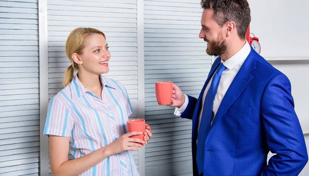 Smiling business couple at office room talking in coffee break. Business and people concept. Work culture. - Foto, imagen