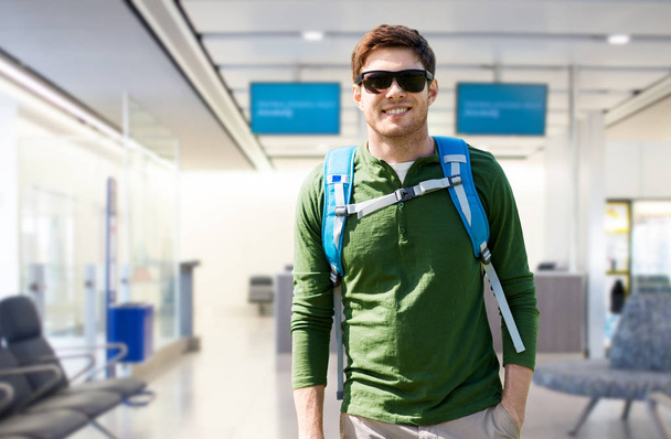 smiling man with backpack over airport terminal - Photo, Image
