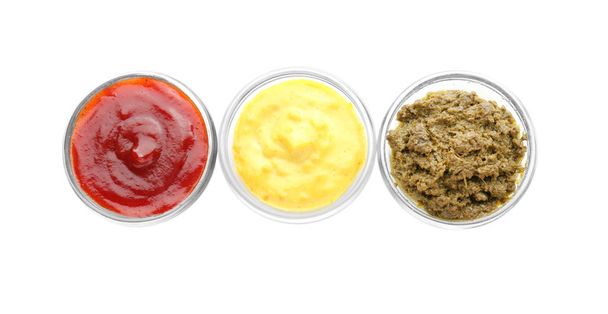 Different tasty sauces in bowls on white background - Photo, Image